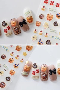 Close-up of 3D embossed nail stickers featuring butter cookies and cute cartoon bear designs