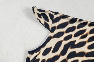 Detailed view of leopard print fabric with precise stitching on the shoulder seam