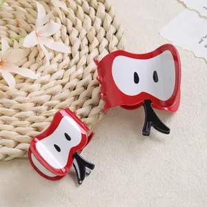 Cute red apple hair claw clip set with white core detail on a rustic summer background