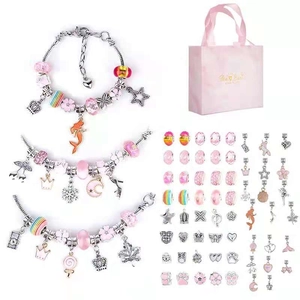 Detailed view of pink DIY charm bracelet set with various beads and gift packaging