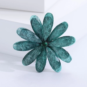 Elegant deep cyan acrylic flower brooch with textured petals on a clean white geometric base