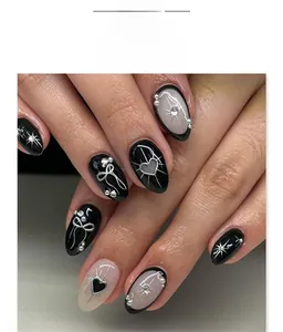 Close-up of Gothic black almond press-on nails with 3D bows, hearts, and silver star accents