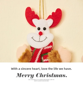 Close-up of reindeer plush ornament with red felt antlers and a red knit scarf decoration