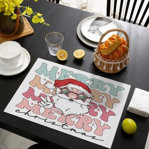 Detail of cotton linen Christmas placemat with Santa Claus illustration on a wooden table