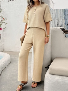 Detail of beige short sleeve knit top and pants set with soft ribbed texture