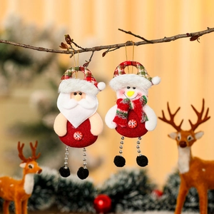 Christmas Santa and Snowman plush hanging ornaments on tree branches with warm decor