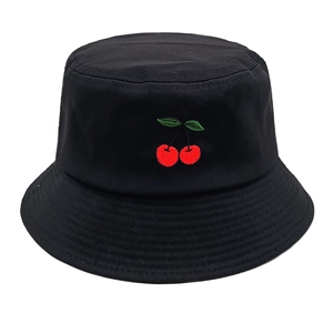 Close-up of red cherry embroidery on a black cotton bucket hat with clean white background