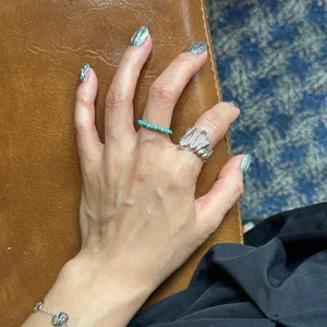 Irregular textured silver wide ring with turquoise beaded band and coin charm bracelet