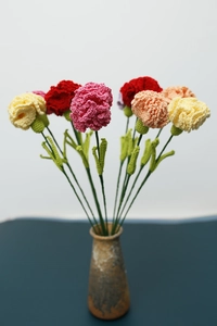 Detail of colorful hand-knitted yarn carnations showing intricate crochet textures