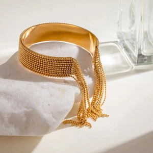 Bracelet manchette en acier inoxydable doré 18 carats avec pampilles élégantes à franges