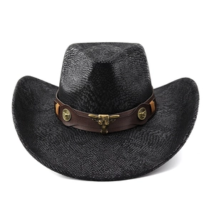 Close-up of black scale texture on cowboy hat with leather band and metal bull head