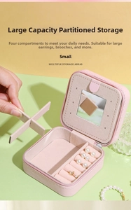 Pink leather jewelry box detail with built-in mirror and adjustable storage dividers