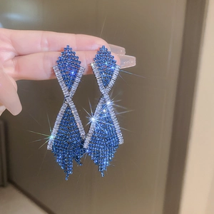 Close-up of luxury royal blue rhinestone tassel earrings with geometric diamond shapes