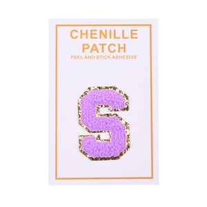 Detailed view of self-adhesive purple chenille letter S patch with gold glitter borders