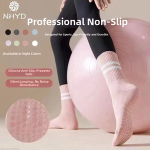 Detail of pink mid-calf yoga socks showing non-slip silicone grips on the bottom