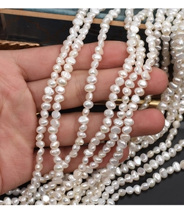 Close-up of natural baroque freshwater pearls showing lustrous white finish on hand