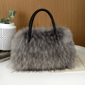 Detail of the high-quality grey faux fur texture and black leather handles on the tote bag