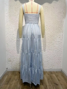 Detail of blue striped backless dress featuring elastic bust and tiered skirt layering