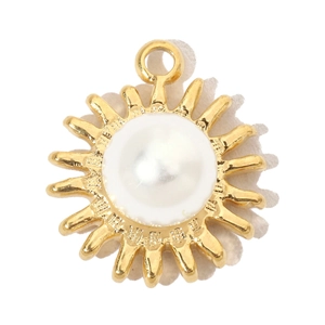 Detailed view of sunburst gold pendant with inlaid white pearl and metallic finish