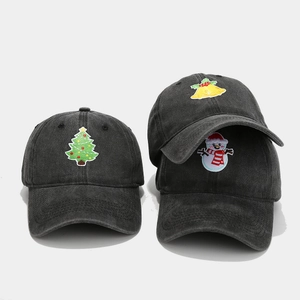Detailed view of three vintage washed cotton baseball caps with Christmas embroidery