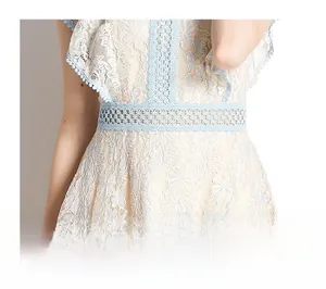 Detailed close-up of light blue floral lace waist with elegant hollow-out stitching