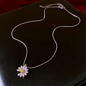 Daisy pendant necklace with white zircon petals and yellow center on silver snake chain
