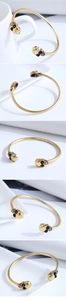Detailed macro view of the gold hollow skeleton skull ends on a vintage metal bangle