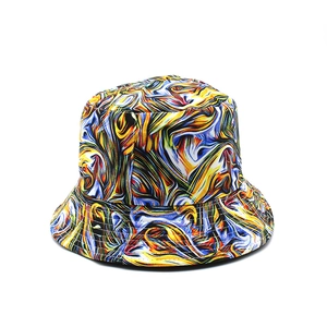 Detail of vibrant abstract marble print on bucket hat with yellow and blue swirls