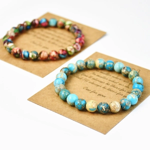Detail of colorful imperial stone beaded stretch bracelets on kraft paper cards