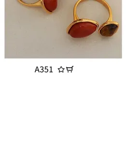Detailed macro view of vintage style gold-plated rings with carnelian and tiger eye stones