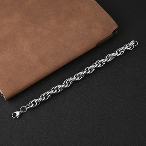 Silver stainless steel rope chain bracelet with lobster clasp on a dark background