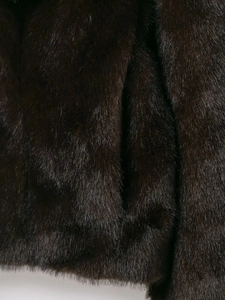 Close-up of deep brown faux fur texture showing soft plush pile and glossy finish