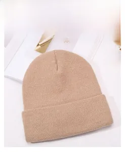 Detail of khaki ribbed knit beanie with soft texture and classic turnover cuff design