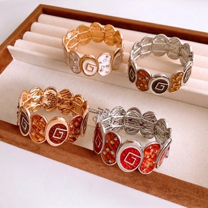 Vintage oval enamel stretch bracelet with star and G letter charms in multiple colors