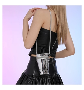 Silver mirror milk tea cup crossbody bag with straw detail shown on model side profile