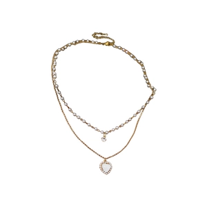 Double layered gold heart necklace with pearls and zircon crystals on white background