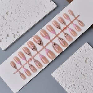 Press on nails with cherry heart motifs and leopard print designs in pink French style