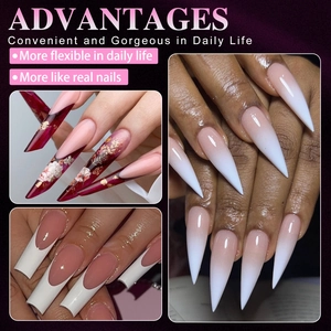 Detail view of various false nail styles including French tips, stiletto, and floral designs