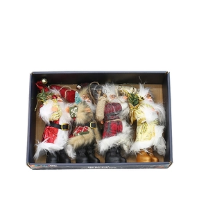 Set of 4 festive Santa Claus figurines in various styles for Christmas home decor