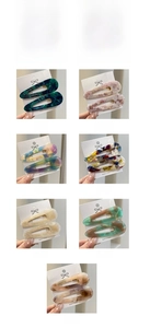 Detailed grid of teardrop acetate hair clips in nine assorted floral and marble patterns