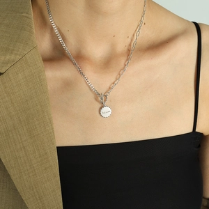 Chic silver OT buckle necklace with 'Beloved' engraved round pendant on elegant model