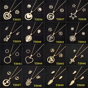 Multiple sets of gold geometric necklaces and earrings featuring stars and hearts on black