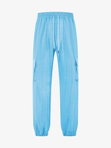 Detail of light blue men's cargo pants showing waffle textured fabric and side flap pocket