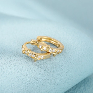 Close-up of golden S925 silver star hoop earrings with sparkling zircon stones