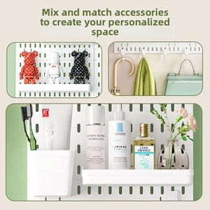 Detail of white pegboard system with hooks and trays for home storage and organization