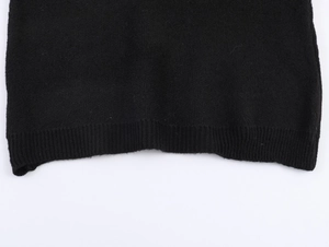 Detail of black knitted ribbed hem showing fine stitch texture for Christmas suit