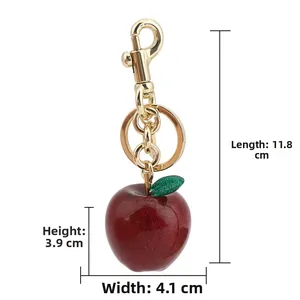 Detail view of red glitter apple keychain with size dimensions in cm and gold lobster clasp