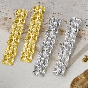 Detail of 304 stainless steel earrings with gold and silver crushed foil texture