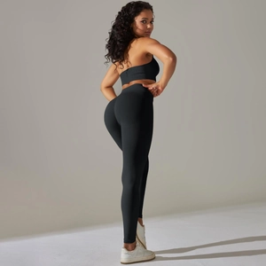 Close-up of seamless black ribbed yoga set featuring high-waist leggings and sports bra