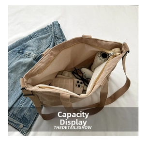 Detail view of corduroy tote bag showing large capacity with daily essentials inside